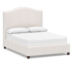 a white bed with two pillows on top of the headboard and foot board, in front of a white background