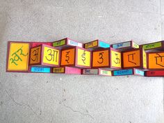 there are many different colored blocks on the floor with words written in each block and numbers arranged around them