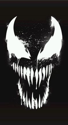 a black and white image of a monster's face with fangs on it, in the dark