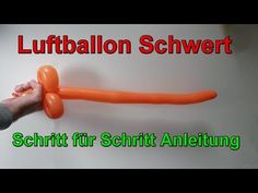 a person holding an orange balloon in their hand with the words luftballon schwert on it