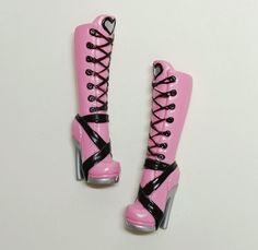 pair of pink and black high heeled boots with laces on the sides, side by side