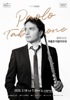 a man in a suit and tie holding a flute