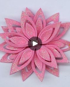 a pink paper flower with glitters on it