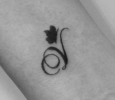 a small tattoo on the wrist of a woman's arm with a flower in it