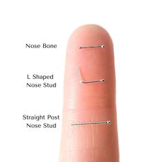 a finger with three different types of nose studs on the tip and one side