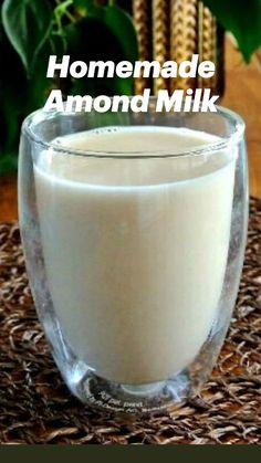 a glass filled with milk sitting on top of a table