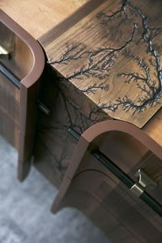 a close up of a wooden table with drawers and handles on it's sides