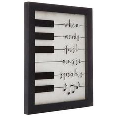 a black and white frame with musical notes on the front, which reads when words fail music speaks