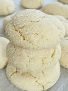 a stack of sugar cookies sitting on top of a pan covered in powdered sugar