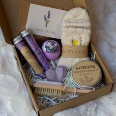 the lavender gift box is packed with personal care items, such as handmade soaps and body scrubs