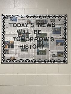 a bulletin board with newspaper clippings hanging on the wall in a public restroom