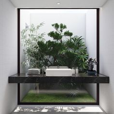 a bathroom with plants on the wall and green grass in the floor, as well as a sink