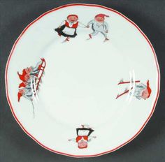 a white plate with red and black designs on the rim, depicting two men holding swords