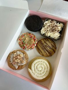 a box filled with assorted pastries on top of a table