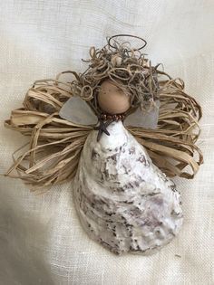 an angel figurine sitting on top of a white cloth