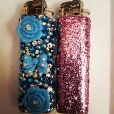 two lighters decorated with blue and pink flowers on top of each other next to each other