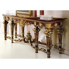 an ornately decorated console table in the corner of a room