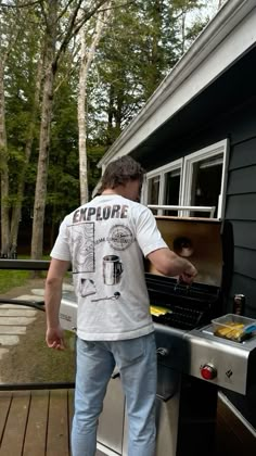 a man grilling food on an outdoor bbq