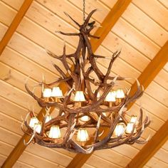 a chandelier made out of antlers hanging from the ceiling