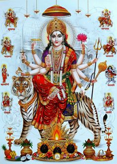 the hindu goddess sitting on top of a tiger