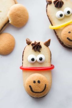 some kind of animal shaped cookies with eyes and nose on it's face, sitting next to other food items