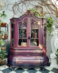 a purple china cabinet sitting on top of a checkered floor