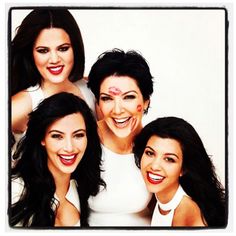 three women with painted faces posing for a photo together in front of a white background