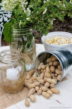 jars filled with food sitting on top of a table next to flowers and other items