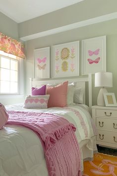 a bedroom with pink and white decor on the walls, bedding and dressers