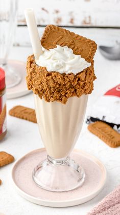 an ice cream sundae with whipped cream and graham crackers in it on a plate