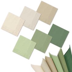 several different colors of napkins on top of each other, including green and beige