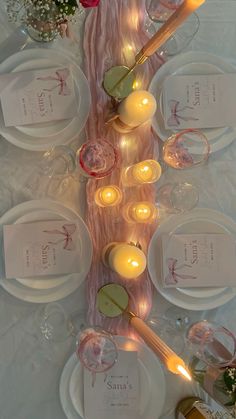 the table is set with candles and place settings