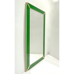 a green mirror sitting on top of a white counter