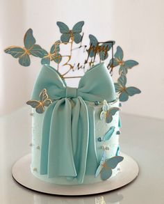 there is a blue cake with butterflies on it