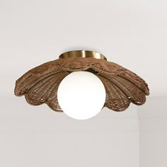 a light that is hanging from the ceiling in a room with white walls and flooring