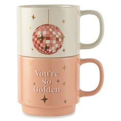 two coffee mugs with the words you're so golden on them