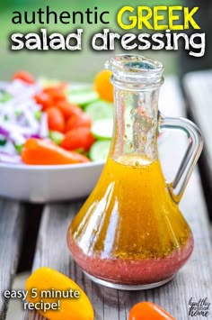 an orange and yellow liquid in a glass bottle next to a bowl of vegetables on a wooden table