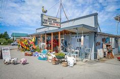 an outdoor market with lots of colorful items on the outside and in front of it