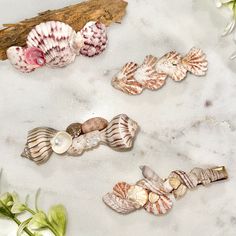 Welcome to our seaside-inspired collection of Shell Barrettes! 🐚 Perfect for adding a touch of coastal charm to any hairstyle, these exquisite barrettes are a must-have accessory for Bridal Showers, Weddings, Beach-goers, and anyone seeking those quintessential summer vibes. Crafted with love and attention to detail, each hair clip varies in size and are made with natural shells. No two barrettes are alike, making each piece a unique treasure to be cherished. Please feel free to send me a message if you would like the exact dimensions of this hair clip.  Whether you're attending a beachside wedding, strolling along the shore, or simply want to infuse your everyday look with a touch of oceanic elegance, these Shell Barrettes are sure to make a splash. Embrace the beauty of the sea and elev Seashell Barrettes, Mermaid Halloween Costumes, Beachside Wedding, Mermaid Halloween, Beach Hair, Mermaid Hair, Barrettes, Summer Hairstyles