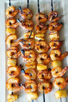 grilled shrimp and pineapple skewers on a tray