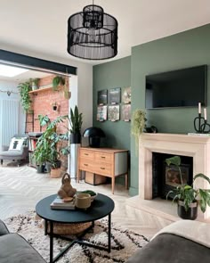 a living room filled with furniture and a flat screen tv mounted to the wall next to a fire place