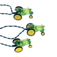 three green toy tractors with yellow wheels are shown on a white background and one is attached to a black cord