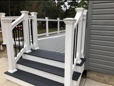 a white and gray deck with black steps