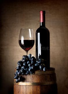 a glass of wine and some grapes on a barrel royalty images, stock photos & more