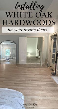 an empty bedroom with white oak floors and hardwood flooring in the foreground is a large mirror that says installing white oak hard