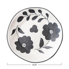 a black and white plate with flowers on it