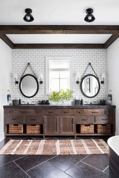 a bathroom with two sinks and mirrors on the wall