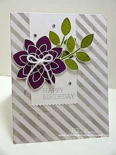 a close up of a birthday card with a flower on the front and green leaves on the back