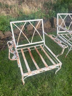 two metal beds sitting on top of green grass