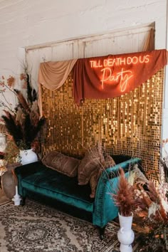 a couch sitting on top of a rug in front of a wall covered in gold sequins